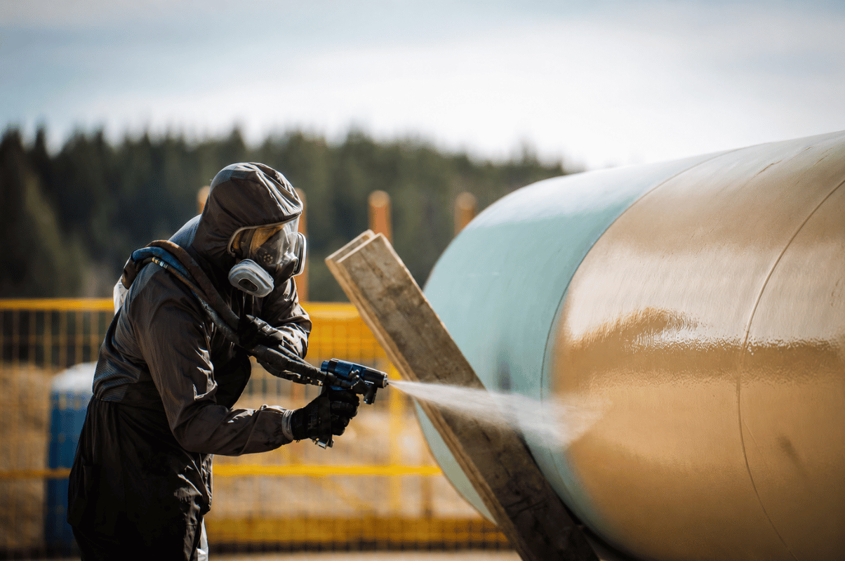 Tennexor polyurea spray coating being applied to oil and gas pipeline